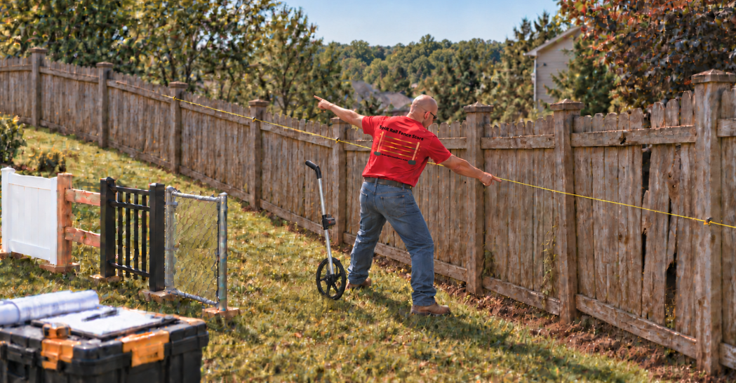 Fence contractor explaining how yard slope affects fence installation cost in Delaware